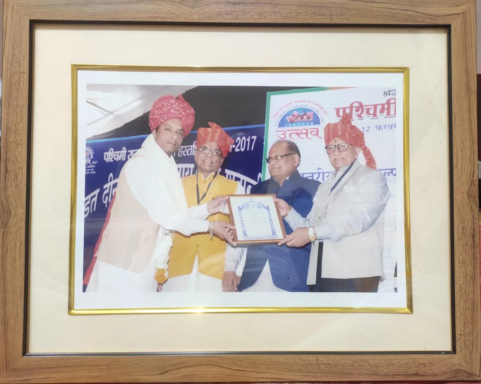 A framed photograph of an award being presented on stage to members of the family in turbans