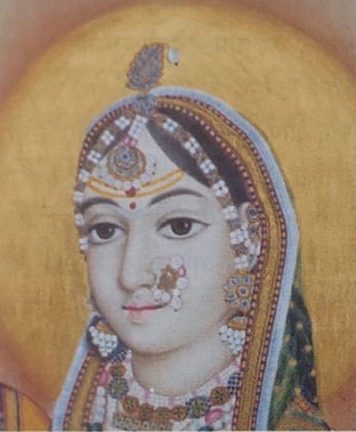 Jaipur-style miniature of a woman's face, with pearl ornaments against a golden halo