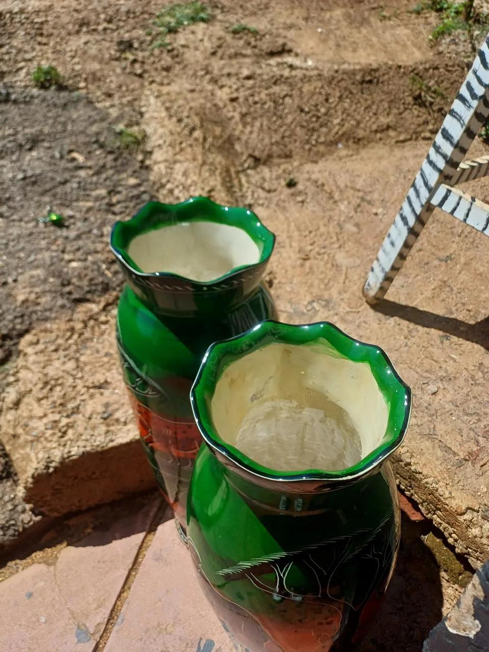 Two hand-painted green soapstone vases with etched designs