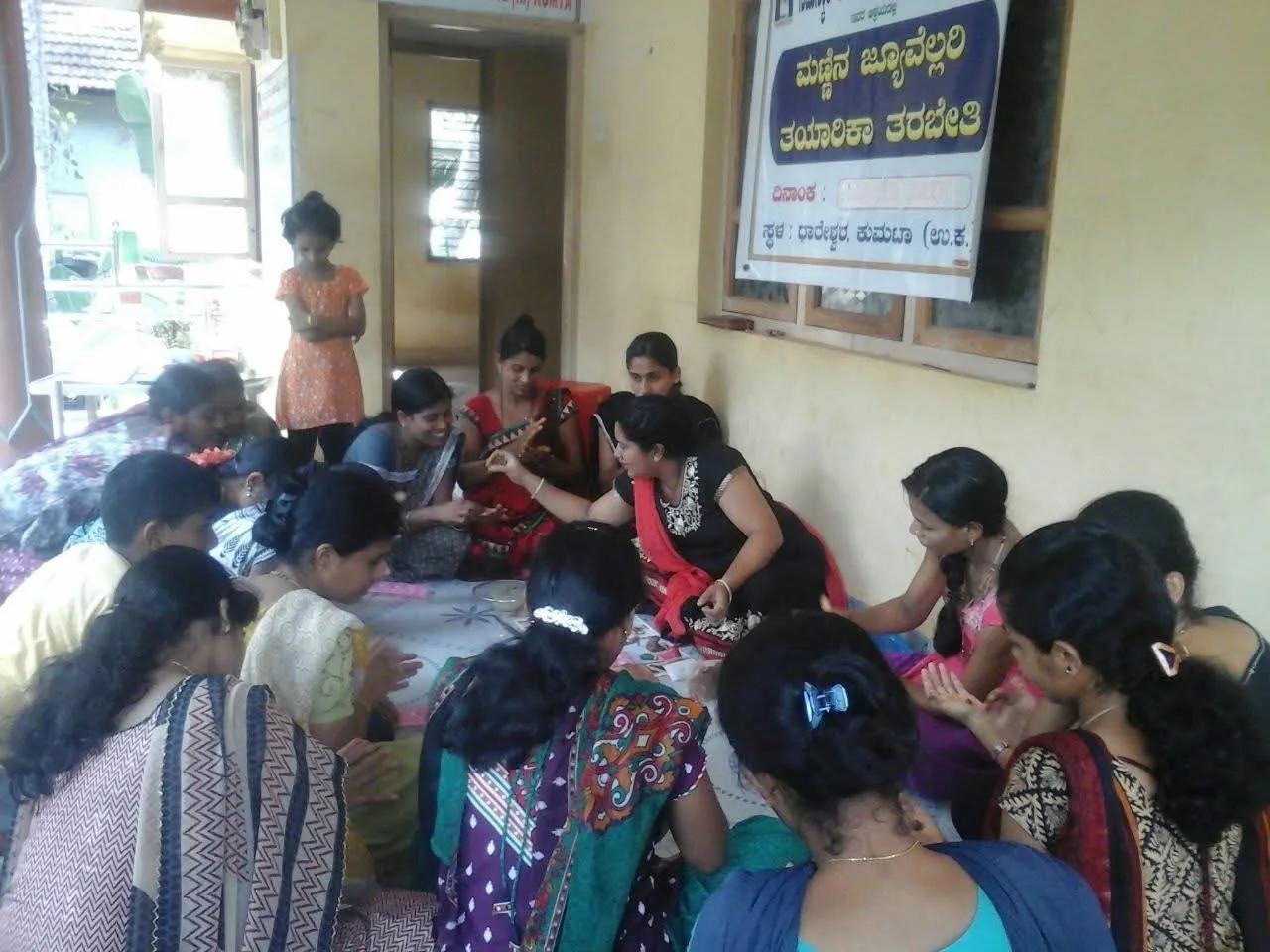 Women making clay jewellery by hand at the workshop in Dhareshwar, Kumta
