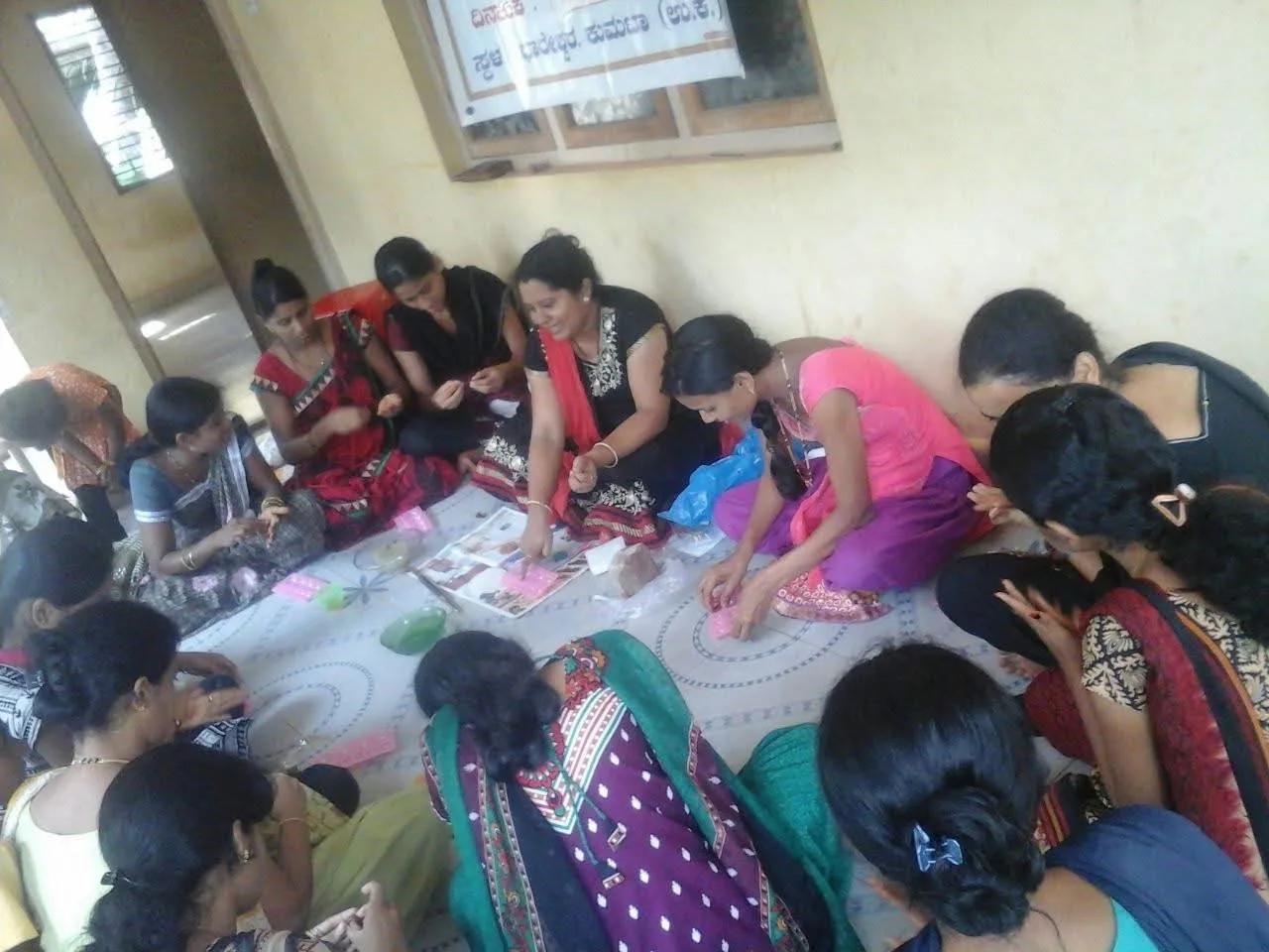 Women making clay jewellery by hand at the workshop in Dhareshwar, Kumta
