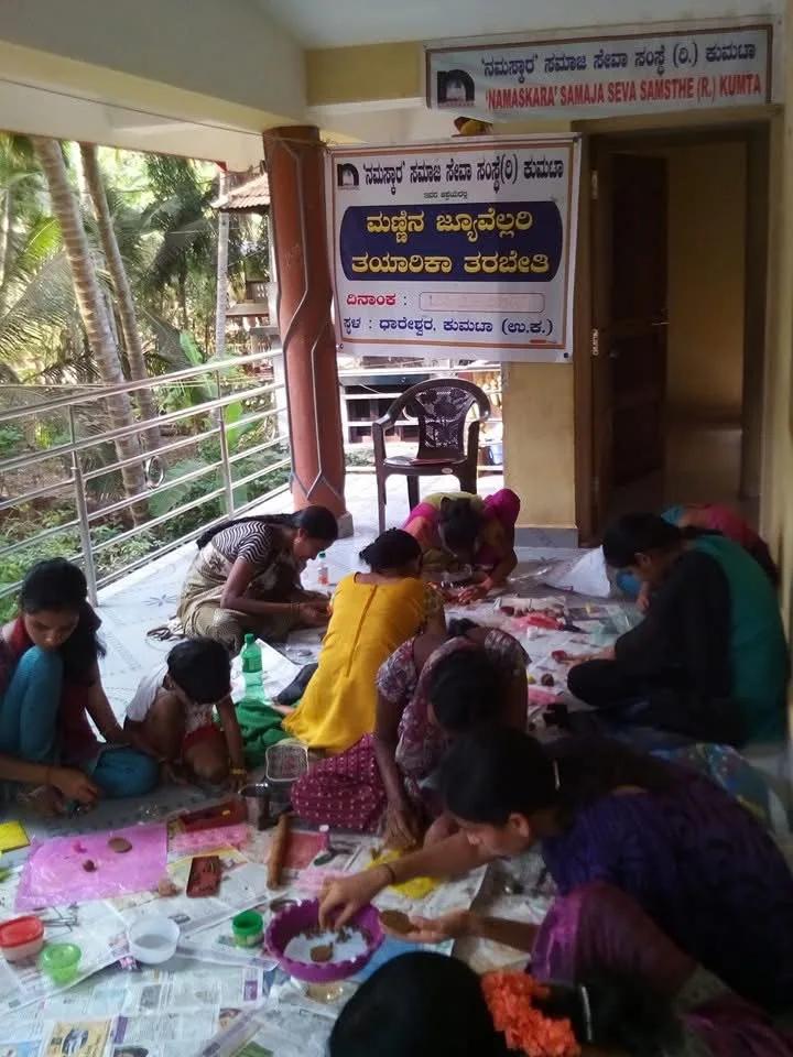 Women making clay jewellery by hand at the workshop in Dhareshwar, Kumta