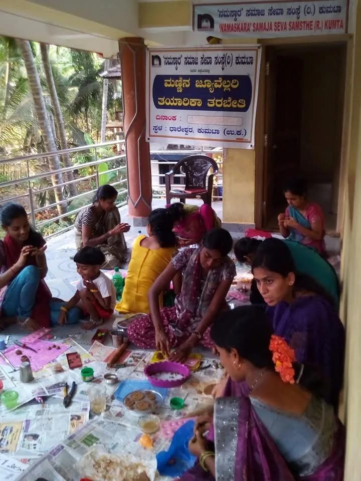 Women making clay jewellery by hand at the workshop in Dhareshwar, Kumta