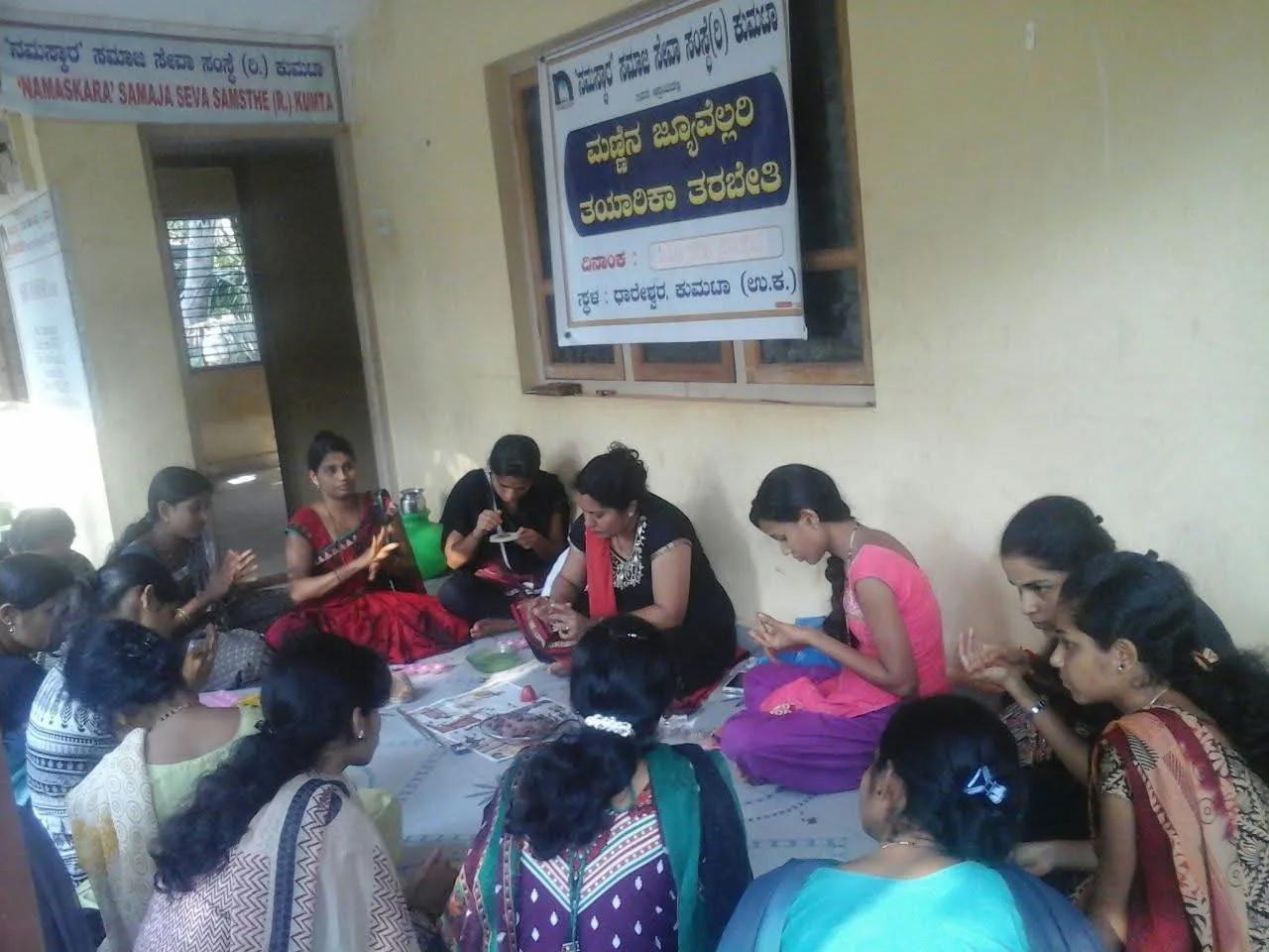 Women making clay jewellery by hand at the workshop in Dhareshwar, Kumta