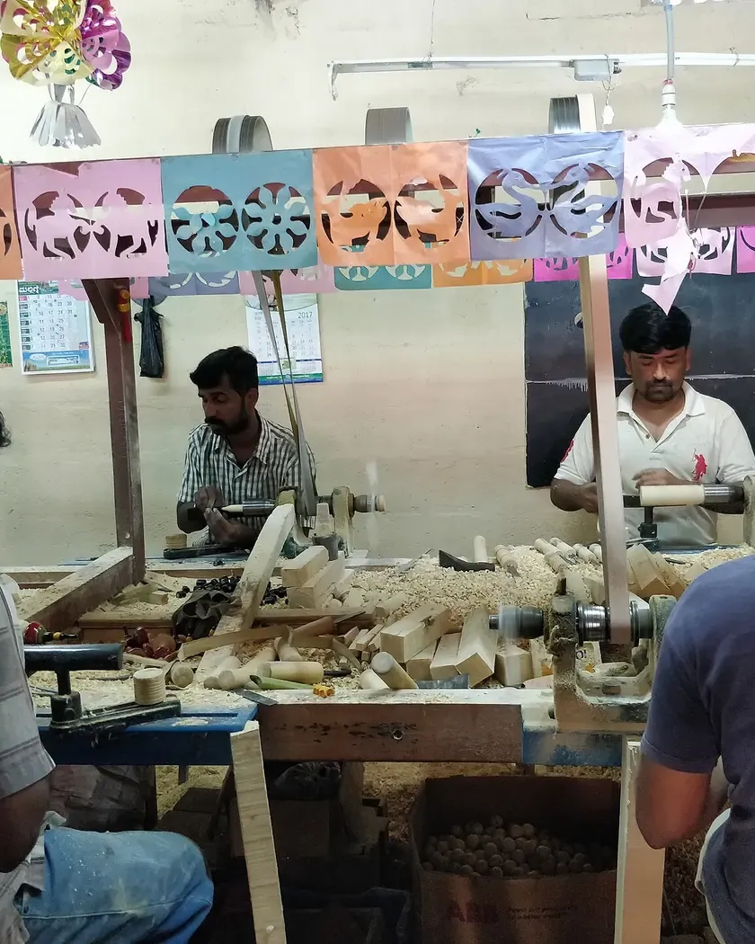 Workers turning wooden toys at lathes in a Channapatna workshop