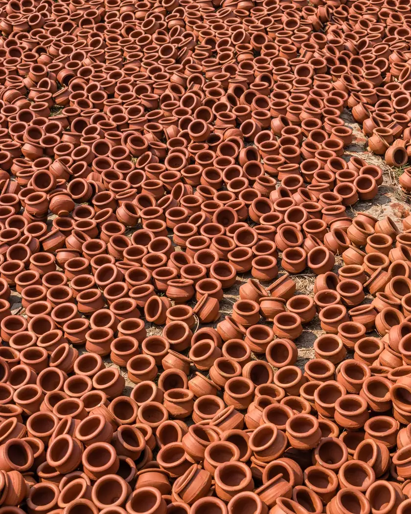 Thousands of terracotta pots laid out in the sun to dry