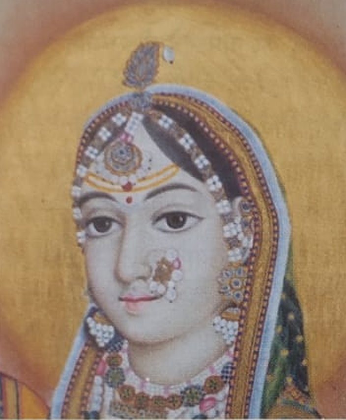 Jaipur-style miniature of a woman's face, with pearl ornaments against a golden halo